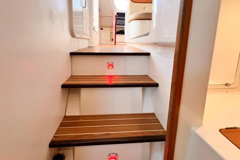Slide: The Image of Staircase inside 2000 Leopard 38 yacht with wooden steps and modern design. - 86