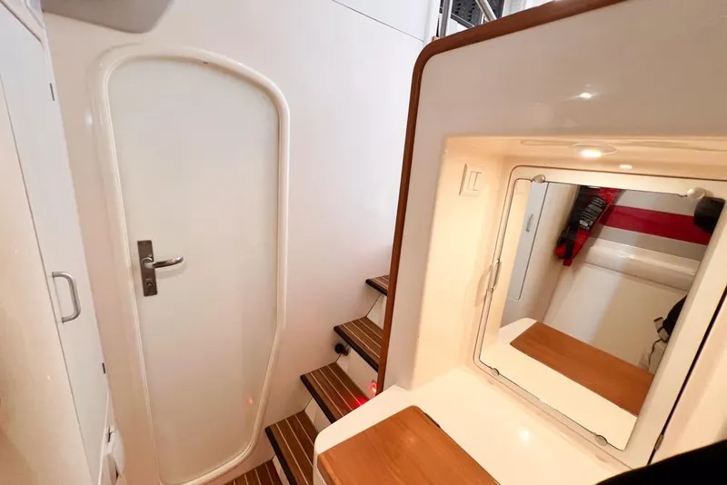 Slide: The Image of Interior of 2000 Leopard 38 yacht with wooden stairs and mirror. - 88