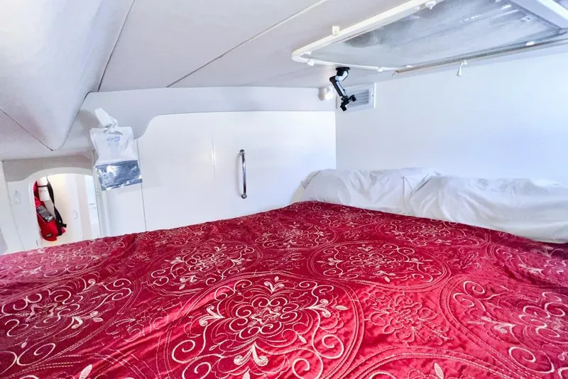 Slide: The Image of Cozy Leopard 38 yacht cabin with red patterned bedding, 2000 model. - 98