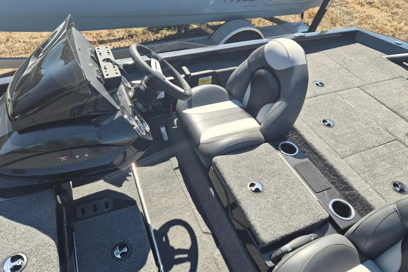 Slide: The Image of 2023 Vexus AVX1880 boat interior with steering wheel and seating, featuring gray upholstery. - 6