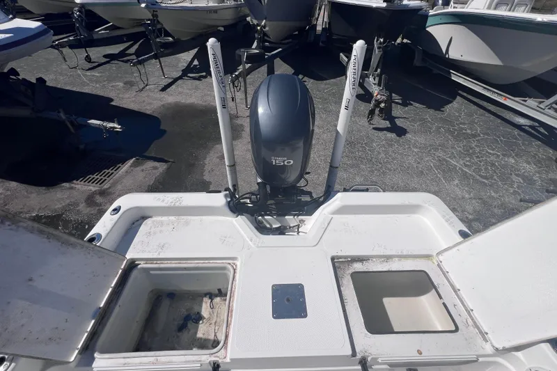 Slide: The Image of 2008 Skeeter ZX20 Bay boat with Yamaha 150 engine, docked among other boats. - 13