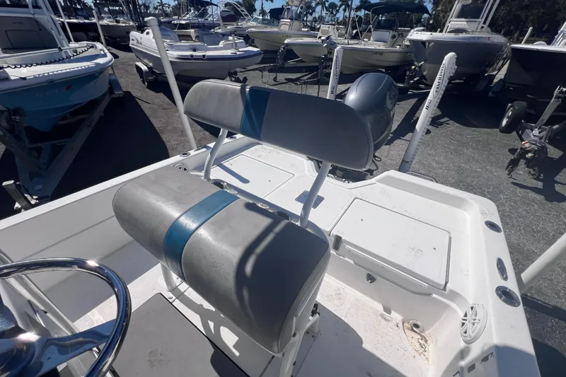 Slide: The Image of 2008 Skeeter ZX20 Bay boat interior with seating and steering wheel, parked among other boats. - 14