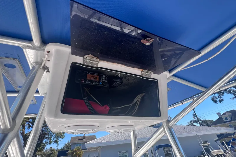 Slide: The Image of 2008 Skeeter ZX20 Bay boat console with radio and wiring under blue canopy. - 23