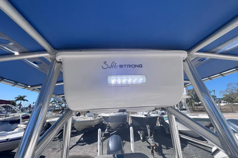 Slide: The Image of 2008 Skeeter ZX20 Bay boat with "Salt Strong" branding and LED light under blue canopy. - 25
