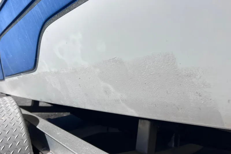 Slide: The Image of 2008 Skeeter ZX20 Bay boat hull with blue accents and visible wear. - 40