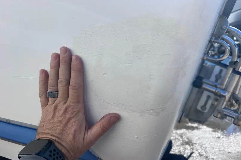 Slide: The Image of Hand touching 2008 Skeeter ZX20 Bay boat hull, showcasing texture and condition. - 41