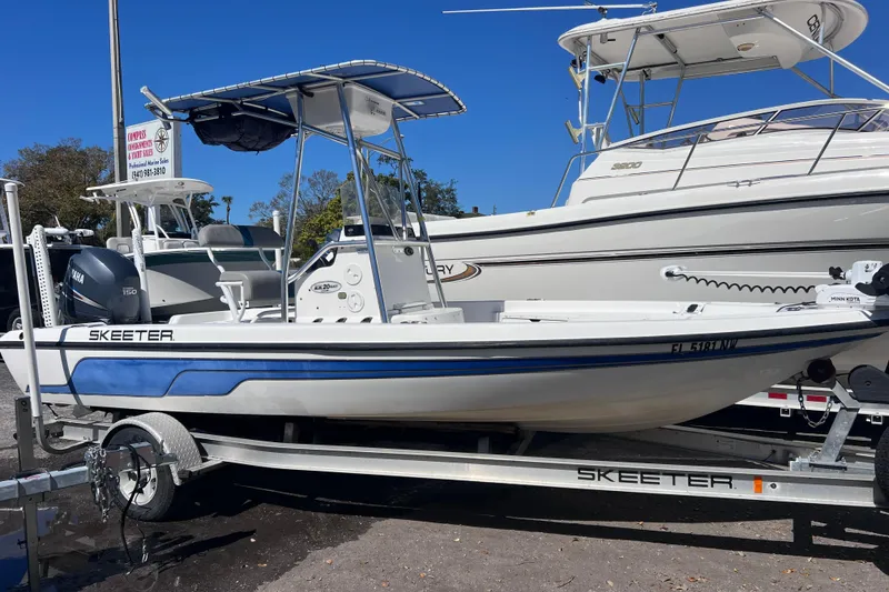 Slide: The Image of 2008 Skeeter ZX20 Bay boat on trailer, featuring Yamaha engine, parked outdoors. - 6