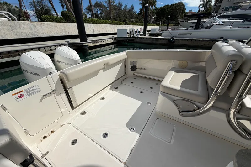 Slide: The Image of 2022 Boston Whaler 320 Vantage boat interior with seating and Mercury engines. - 10