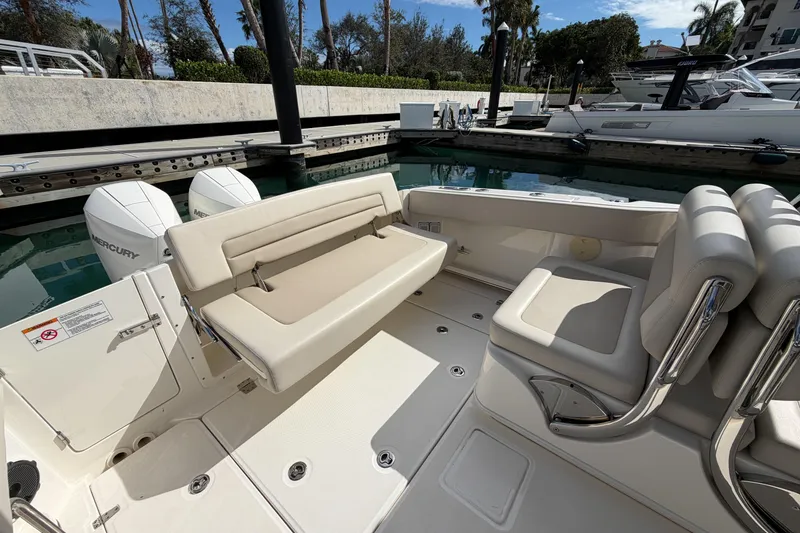 Slide: The Image of 2022 Boston Whaler 320 Vantage boat interior with seating and twin Mercury engines. - 11