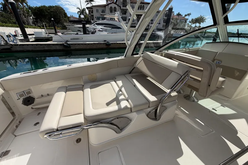 Slide: The Image of 2022 Boston Whaler 320 Vantage interior with luxurious seating at marina. - 13