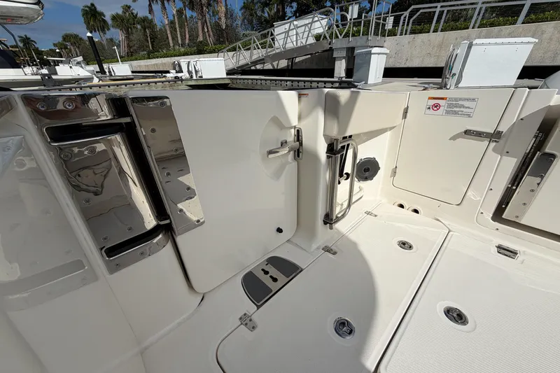 Slide: The Image of 2022 Boston Whaler 320 Vantage boat interior with stainless steel features and white deck. - 15