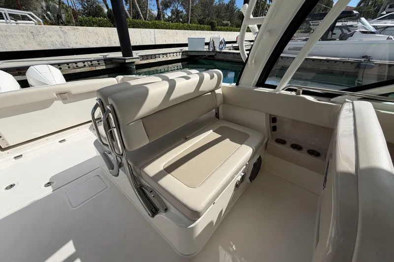 Slide: The Image of 2022 Boston Whaler 320 Vantage interior seating area with beige upholstery. - 17