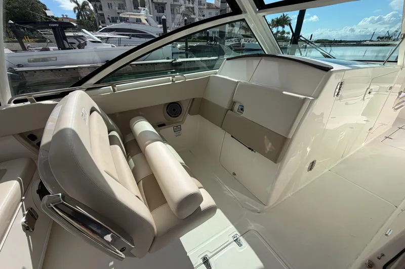 Slide: The Image of 2022 Boston Whaler 320 Vantage interior with beige seating and sleek design. - 18