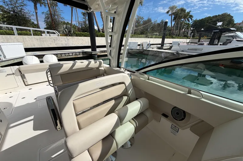 Slide: The Image of 2022 Boston Whaler 320 Vantage interior with luxurious seating and waterfront view. - 19