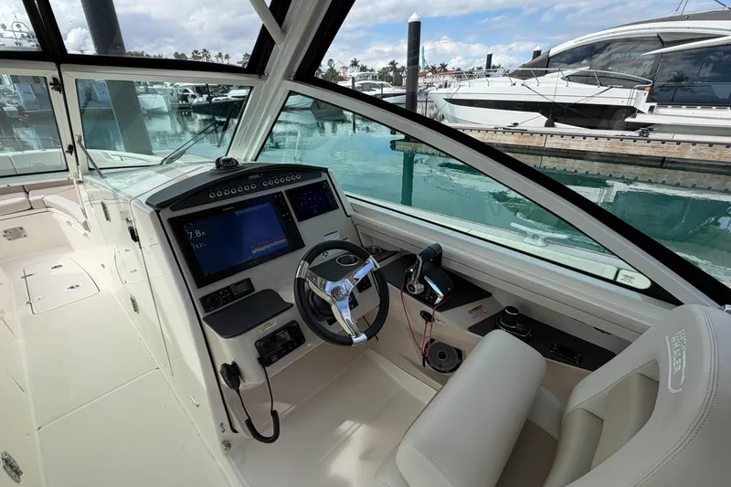 Slide: The Image of 2022 Boston Whaler 320 Vantage boat interior with modern dashboard and steering wheel. - 27