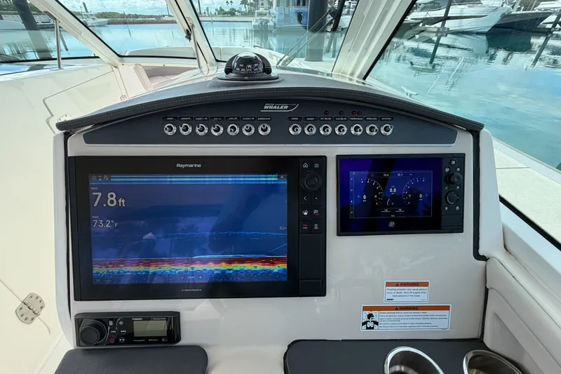 Slide: The Image of Cockpit of 2022 Boston Whaler 320 Vantage with advanced navigation displays. - 29