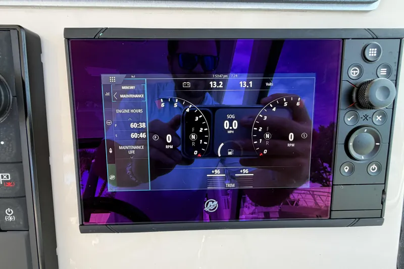 Slide: The Image of 2022 Boston Whaler 320 Vantage dashboard display showing engine hours and maintenance details. - 32
