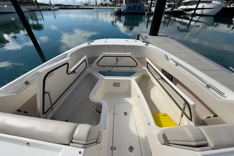 Slide: The Image of 2022 Boston Whaler 320 Vantage boat interior with open storage compartments at marina. - 39