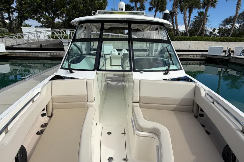 Slide: The Image of 2022 Boston Whaler 320 Vantage boat with spacious seating and sleek design at a marina. - 40