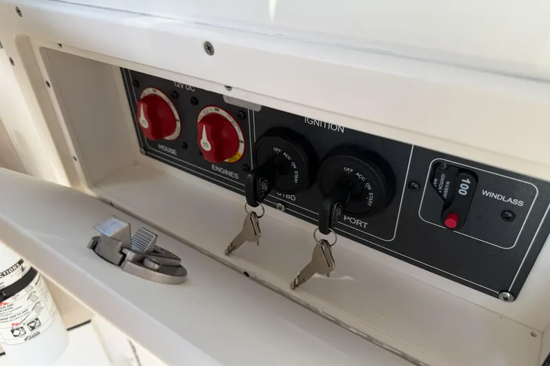Slide: The Image of Control panel of a 2022 Boston Whaler 320 Vantage boat with ignition keys. - 47