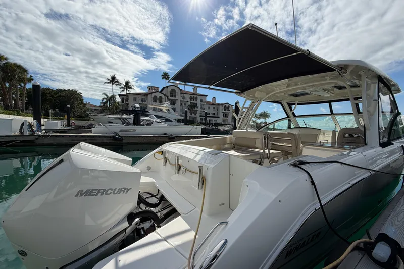 Slide: The Image of 2022 Boston Whaler 320 Vantage docked, featuring Mercury engines and spacious seating. - 5