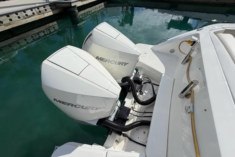 Slide: The Image of 2022 Boston Whaler 320 Vantage with dual Mercury outboard engines docked. - 7