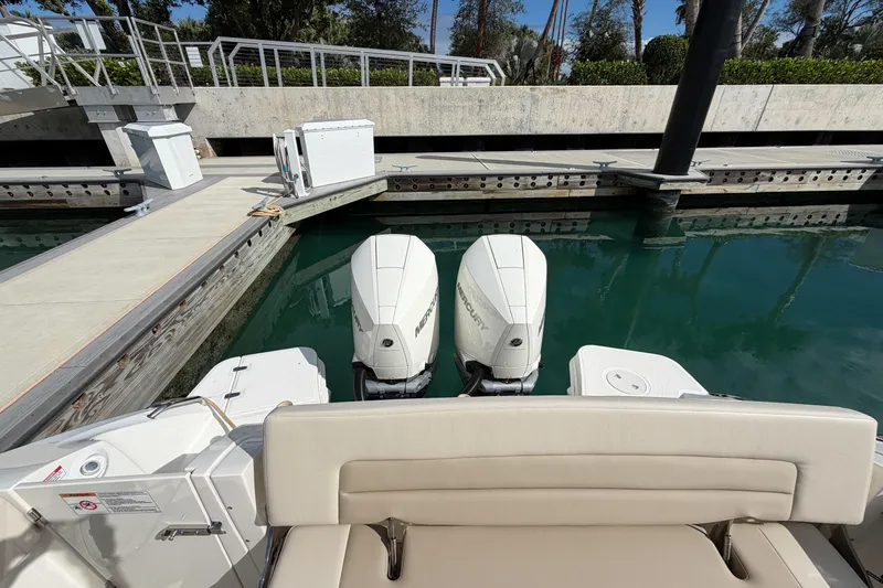 Slide: The Image of 2022 Boston Whaler 320 Vantage docked, featuring dual Mercury outboard engines. - 8