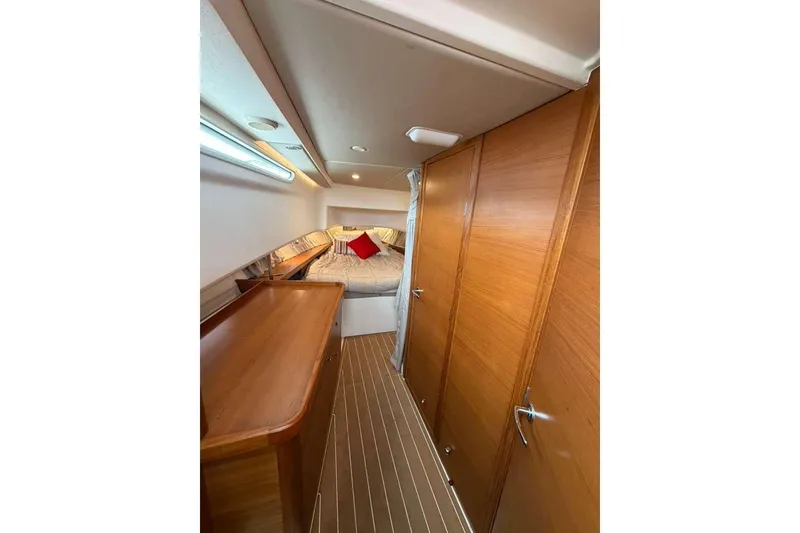 Slide: The Image of Luxurious interior of 2021 Nimbus T-11 boat with wood paneling and cozy bed. - 11