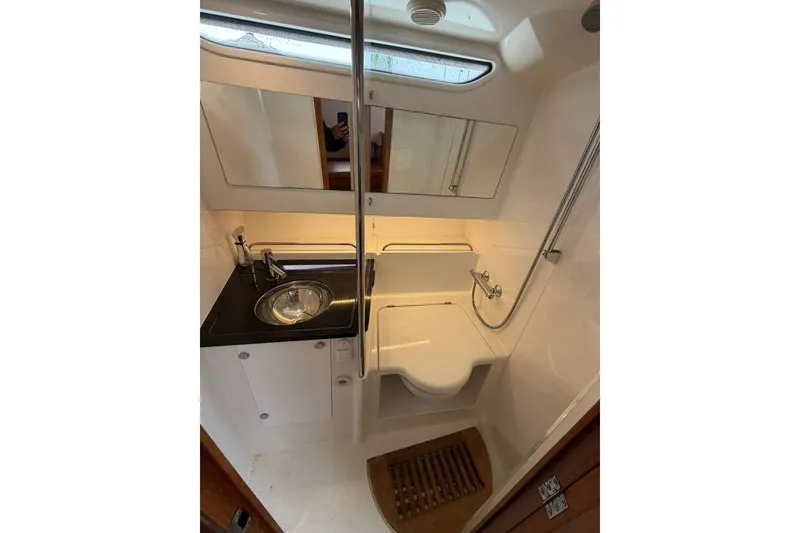 Slide: The Image of Compact bathroom in 2021 Nimbus T-11 boat with sink, shower, and mirror. - 15