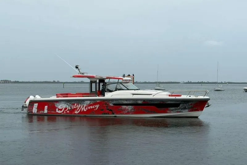 The Image of Nimbus T-11 2021 boat with red and white design docked at marina. - 0