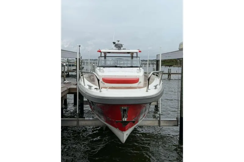 Slide: The Image of 2021 Nimbus T-11 boat docked at marina, front view. - 2