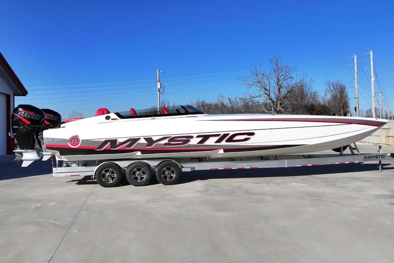 The Image of 2019 Mystic Powerboats C3800 on trailer, featuring sleek design and twin outboard engines. - 0