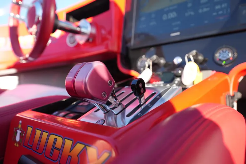 Slide: The Image of 2019 Mystic Powerboats C3800 cockpit with red controls and steering wheel. - 13