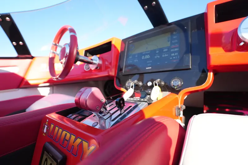 Slide: The Image of 2019 Mystic Powerboats C3800 cockpit with red interior and advanced navigation system. - 14
