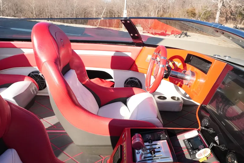 Slide: The Image of 2019 Mystic Powerboats C3800 cockpit with red and white leather seats, modern controls, and steering wheel. - 19