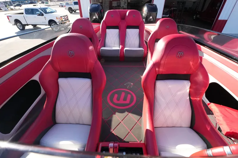 Slide: The Image of 2019 Mystic Powerboats C3800 interior with red and white seating, showcasing luxury design. - 21