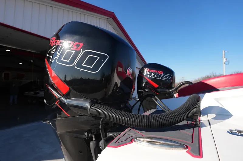 Slide: The Image of 2019 Mystic Powerboats C3800 with Racing 400 engines, docked near a red-roofed building. - 26