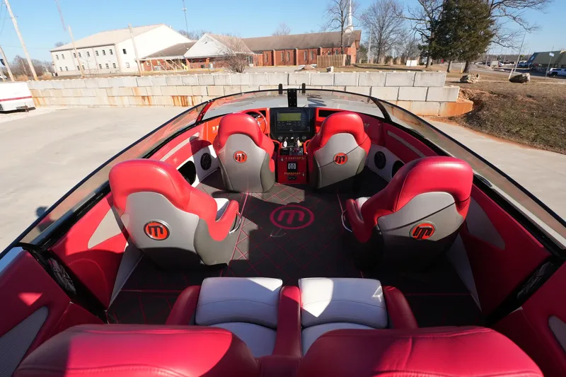 Slide: The Image of Interior of 2019 Mystic Powerboats C3800 with red and gray seating, modern dashboard. - 27