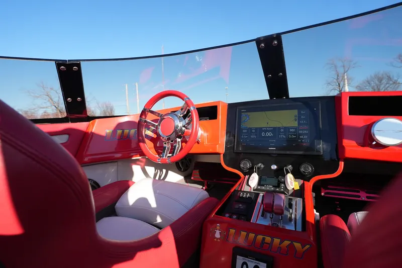 Slide: The Image of 2019 Mystic Powerboats C3800 cockpit with red interior and advanced navigation system. - 28