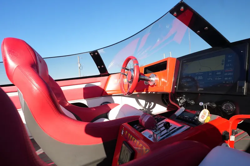 Slide: The Image of 2019 Mystic Powerboats C3800 cockpit with red leather seats and advanced navigation system. - 29