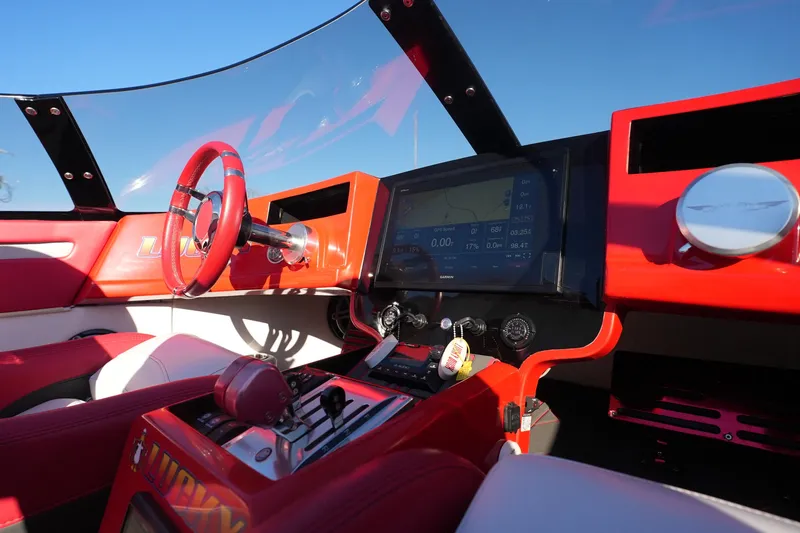 Slide: The Image of 2019 Mystic Powerboats C3800 cockpit with red interior and advanced navigation display. - 30