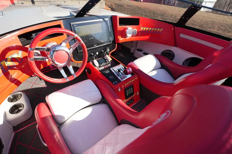 Slide: The Image of 2019 Mystic Powerboats C3800 cockpit with red and white seats, modern controls, and vibrant design. - 31