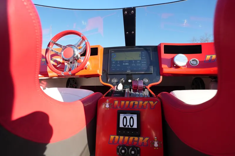 Slide: The Image of Cockpit of 2019 Mystic Powerboats C3800 with red accents and digital display. - 36
