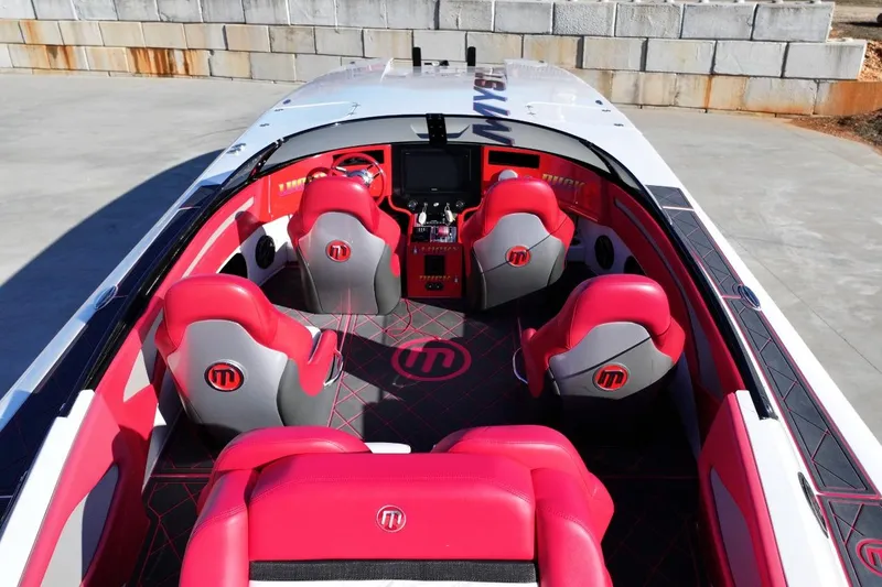 Slide: The Image of 2019 Mystic Powerboats C3800 interior with red and gray seating, modern dashboard, and sleek design. - 6