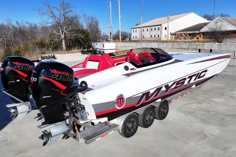 Slide: The Image of 2019 Mystic Powerboats C3800 with dual Mercury Racing 400 engines, parked on a trailer. - 7