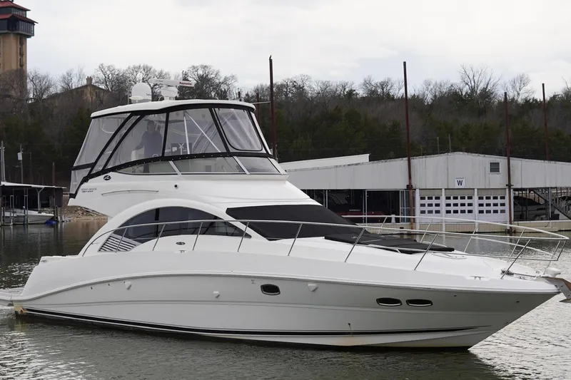 Slide: The Image of 2009 Sea Ray 47 Sedan Bridge yacht docked at marina, overcast sky. - 12