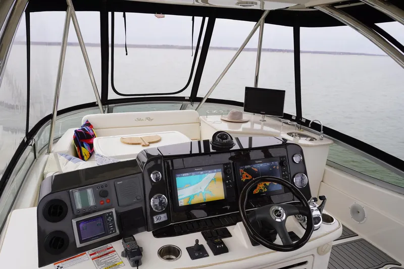 Slide: The Image of 2009 Sea Ray 47 Sedan Bridge helm with navigation screens and panoramic water view. - 15