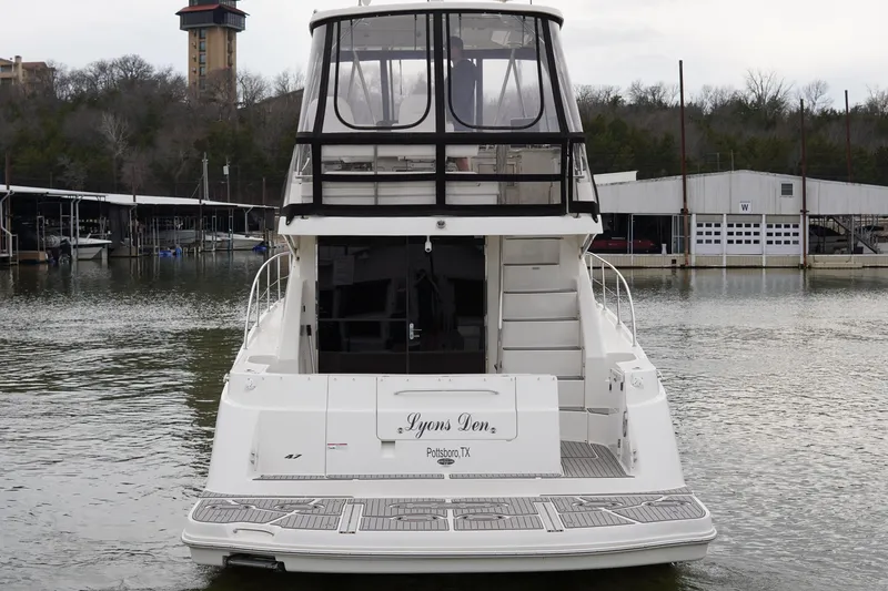 Slide: The Image of 2009 Sea Ray 47 Sedan Bridge yacht docked at marina, rear view. - 2