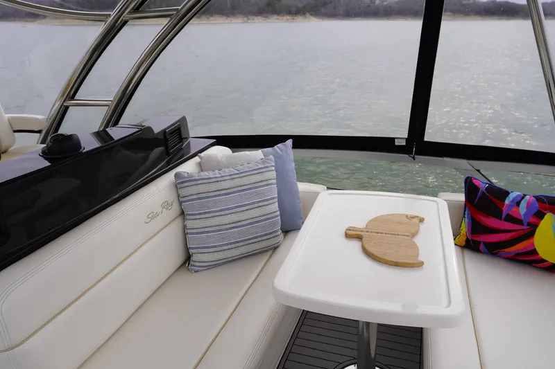 Slide: The Image of Luxurious interior of 2009 Sea Ray 47 Sedan Bridge with cushions and table. - 20