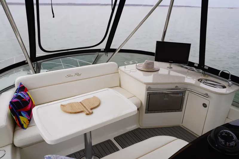Slide: The Image of Luxurious interior of 2009 Sea Ray 47 Sedan Bridge yacht with seating and kitchenette. - 21